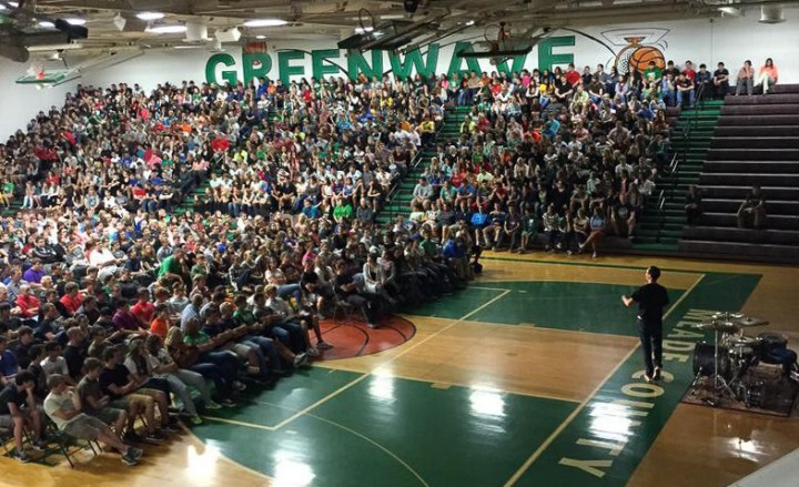 Adam speaking to large crowd