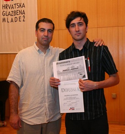 Petar Curic presents camper Valerio Lucantoni a scholarship to study at Drummers Collective in New York.